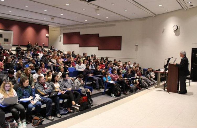 classroom full of students & a speaker